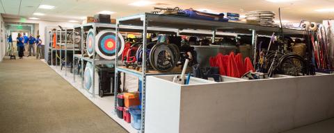 rental equipment on shelves in large storeroom