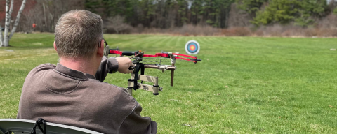 man shooting modified bow