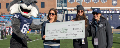 accepting donation check at football game