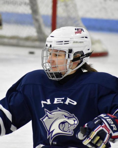 Catherine on the ice in hockey gear