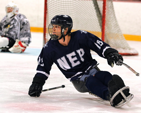 Man playing sled hockey